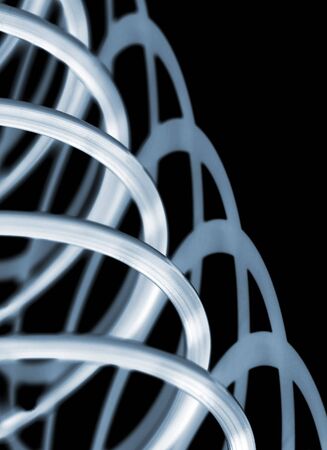 Abstract pattern of toy flexi-spring over blackの写真素材