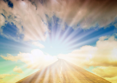 Country road disappearing into cloudy skyの写真素材