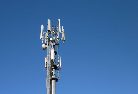 Closeup of transmitter tower against cloudless blue sky