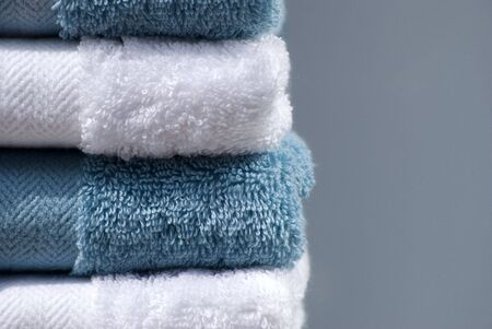 Blue and white cotton towels on plain backgroundの写真素材