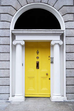 Georgian style yellow wooden door in houseの写真素材