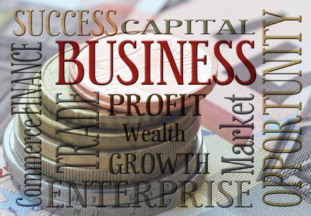 Euro coins and banknotes with words relating to businessの写真素材