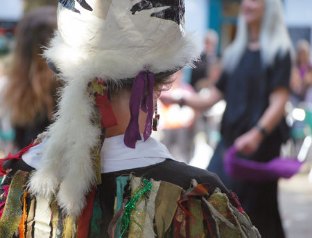 Morris Dancer looks on at group of dancers