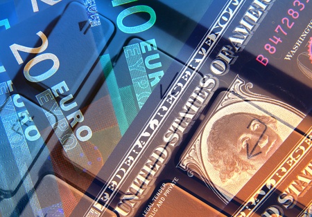 Dollar and Euro banknotes overlaid with keyboard abstractの写真素材