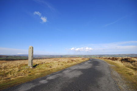 Deserted road through Yorkshire Moors on sunny day