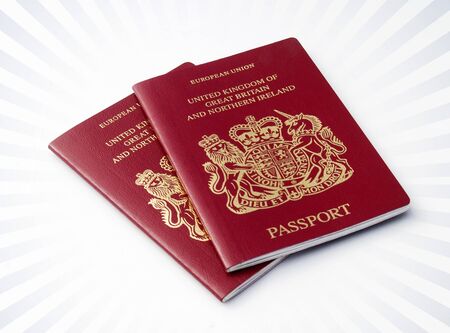 Two British passports over a stripe backgroundの写真素材