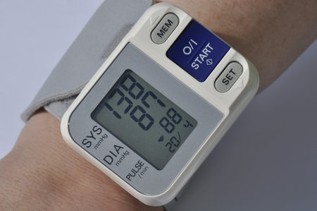 Closeup of female wearing wrist blood pressure meterの写真素材