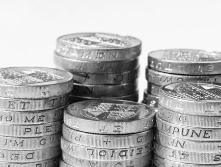 Stack of UK coins on white background