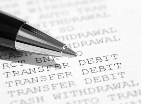Closeup of pen resting on a bank statement
