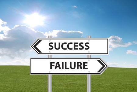Success or failure sign in front of grass and cloudy blue skyの写真素材
