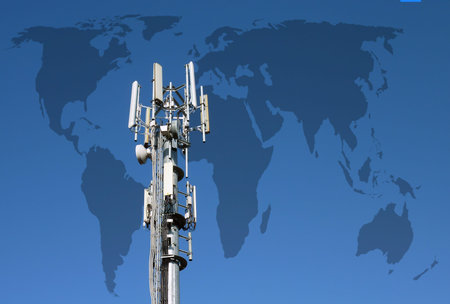 Closeup of transmitter tower against World outline map