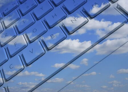 Closeup of laptop keyboard overlaid with cloud effectの写真素材