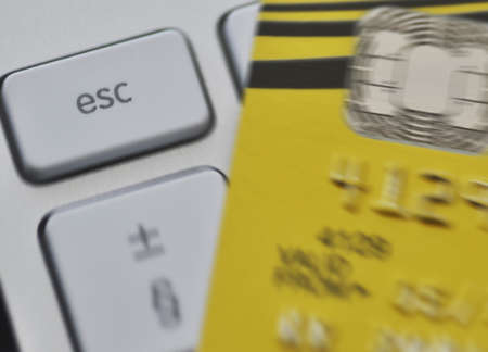 Zoom effect centered on computer Escape key with blurred credit card   Escaping debt  の写真素材