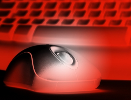 Closeup of computer keyboard and mouse colored red.の写真素材