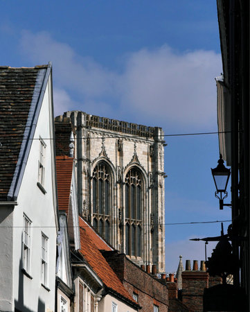 View of York Minster tower rising above Stonegate houses and shops.