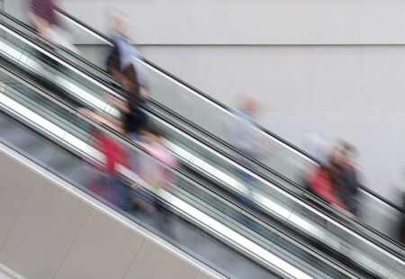People travelling on escalator taking with slow shutter speed to show movementの写真素材