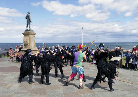 WHITBY, NORTH YORKSHIRE, UK. Circa AUGUST 2014. Traditional Morris Dancers perform in front of tourists during Whitby's Folk Festival.のeditorial素材