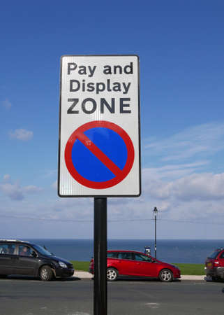 Pay and Display Zone sign with cars in backgroundの写真素材