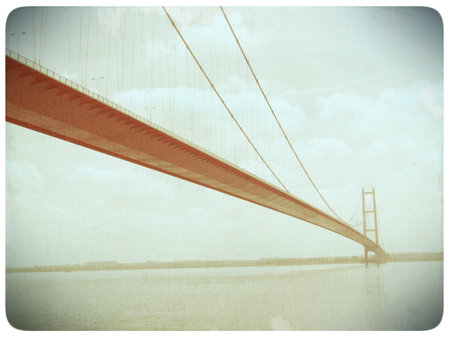 Faded old film effect applied to image suspension bridge over the River Humber