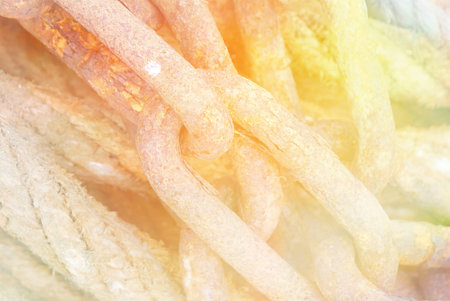 Color lighting effects applied to rusty chain and ropeの写真素材