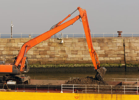 Dredging ship scooping soil from River Esk in Whitbyの写真素材