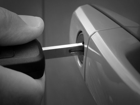 Extreme closeup of man inserting key into car lock