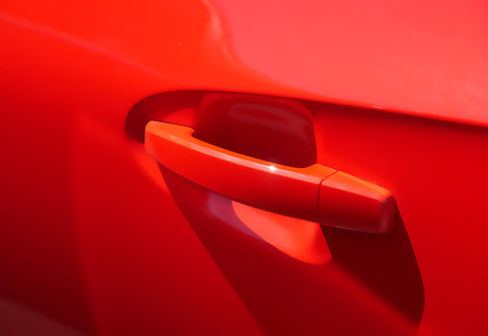 Closeup of door handle of a red modern car.の写真素材
