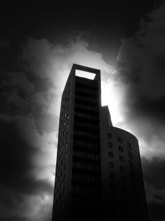 Darkly lit city tower block with added dark edges for effect.の写真素材