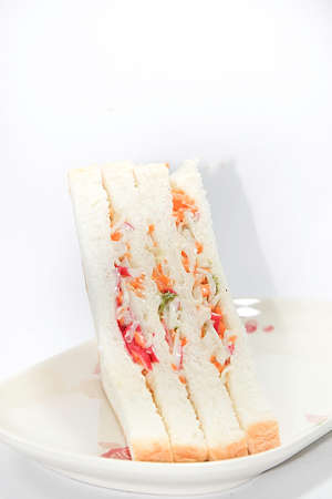 Healthy ham sandwich with cheese, tomato - lettuce - corn - carrot on white background.の写真素材