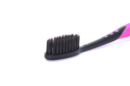 Charcoal toothbrush on a white background that cleans teeth with charcoal, designed for health-conscious people, environmentally friendly.の写真素材