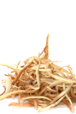 Sliced Fingerroot, ready to cook as spices and herbs on a white background.