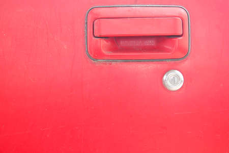 Car door - lock - old classic red car that is being repaired.の写真素材