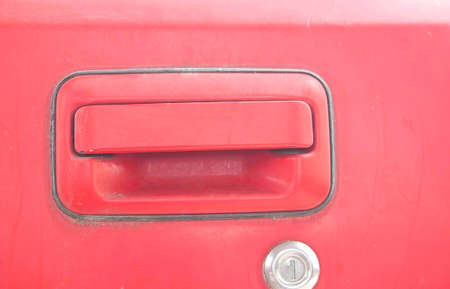 Car door - lock - old classic red car that is being repaired.の写真素材