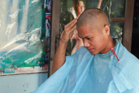 Thai men shave their hair for the ordination of monks - to replace the grace of parents in Thailand's Buddhism - 2- 2015-Nakhon Pathom, Thailand.のeditorial素材
