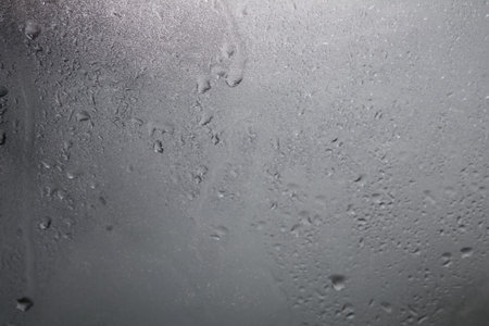 Raindrops on a black background Water droplets on a dark background Rain protection glass for cars...
