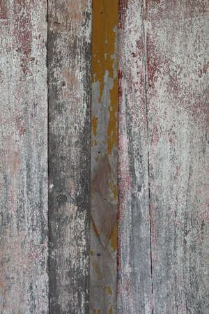 Old wooden door For more than eighty years in the sun and for a long time it is deteriorating with time and the color is peeling off the wood.の写真素材