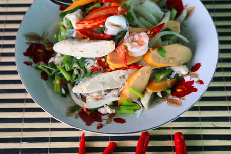 Spicy Vermicelli Salad Ready to Serve on Plates - Spicy Taste is a healthy food, a traditional Thai food with shrimp-squid-sausage ingredients made at home.の写真素材