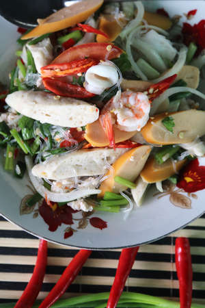 Spicy Vermicelli Salad Ready to Serve on Plates - Spicy Taste is a healthy food, a traditional Thai food with shrimp-squid-sausage ingredients made at home.の写真素材