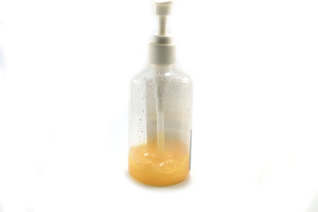 Wrinkle Treatment Facial Serum is a lotion of pure and natural extracts-mixed gold leaf-in a medium plastic bottle on a separate white background, popular with young people these days.の写真素材