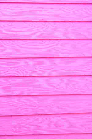 wooden windows and glass and the pink walls of the house are plasterwood that is popularly used to build houses these days. It is a modern style house and is becoming popular to replace the real wood.の写真素材