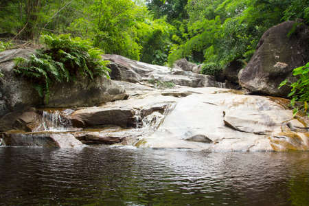 Flowing from high to low, man-made waterfalls irrigate and create an ecotourism attraction with granite and limestone and natural trees as a summer attraction.の写真素材