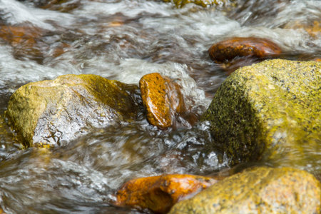 water that flows the  in the waterfall in the dry summer makes the mixture of granite and limestone...
