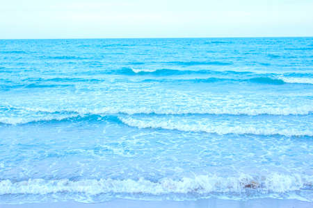 strong wind and ocean waves hit the shore. In the evening, the sea floor was blue, alternating with the grit of sand for a period that nature created, beautiful and scary.の写真素材