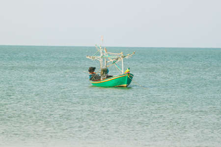 small fishing boat that catches fish and squid along the coast in a traditional way and maintains an ecosystem of fish and marine life for a long time on strong and windy days.の写真素材