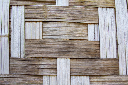 Walls of houses, artfully woven with dry bamboo, are a traditional way of life in rural Asia - Thailand, Laos, and Kampucha.の写真素材