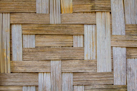 Walls of houses, artfully woven with dry bamboo, are a traditional way of life in rural Asia - Thailand, Laos, and Kampucha.の写真素材