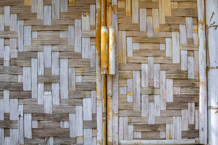 Walls of houses, artfully woven with dry bamboo, are a traditional way of life in rural Asia -...
