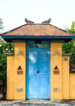 blue wooden door of a house designed and decorated in Balinese style is beautiful and durable yet has a designer design that is perfect and private.の写真素材
