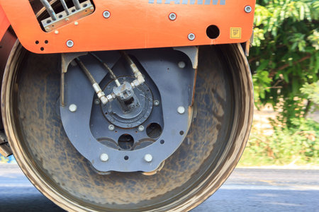 machinery is grinding asphalt on roads that are undergoing road construction and repairs, making...