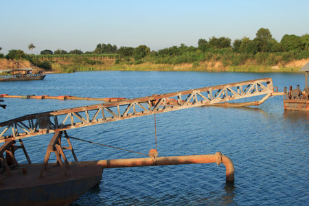 Suction boat's steel pipes are transporting sand from deep rivers for use in the construction of...